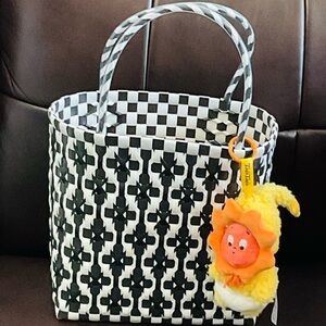 Stylish Black and White Floral Tote with Plush Charm